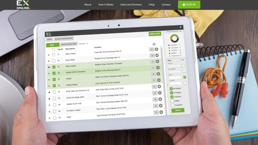 Hands holding a tablet running Ex-Online checksheets